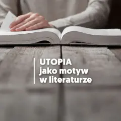 Otwarta księga na drewnianym stole, sugerująca poszukiwanie odpowiedzi na pytanie: utopia co to? W tle dłonie przewracające kartki.