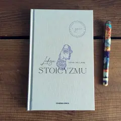 Książka "Lekcje stoicyzmu" Johna Sellarsa obok ozdobnego pióra. Inspiracja dla tych, którzy szukają mądrości w literaturze.