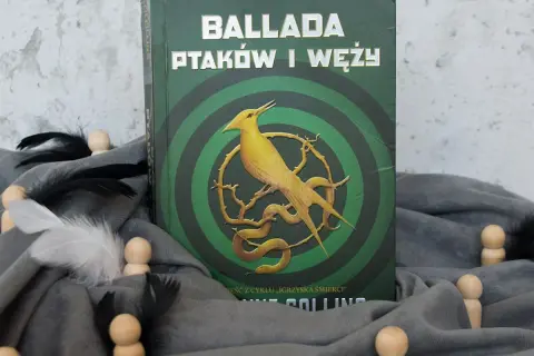 Okładka "Ballady ptaków i węży" z cyklu "Igrzyska Śmierci". Żółty ptak i wąż na tle zielonych kręgów.