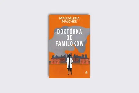 Okładka książki "Doktórka od familoków" Magdaleny Majcher. Sylwetka kobiety w białym fartuchu na tle industrialnego krajobrazu.